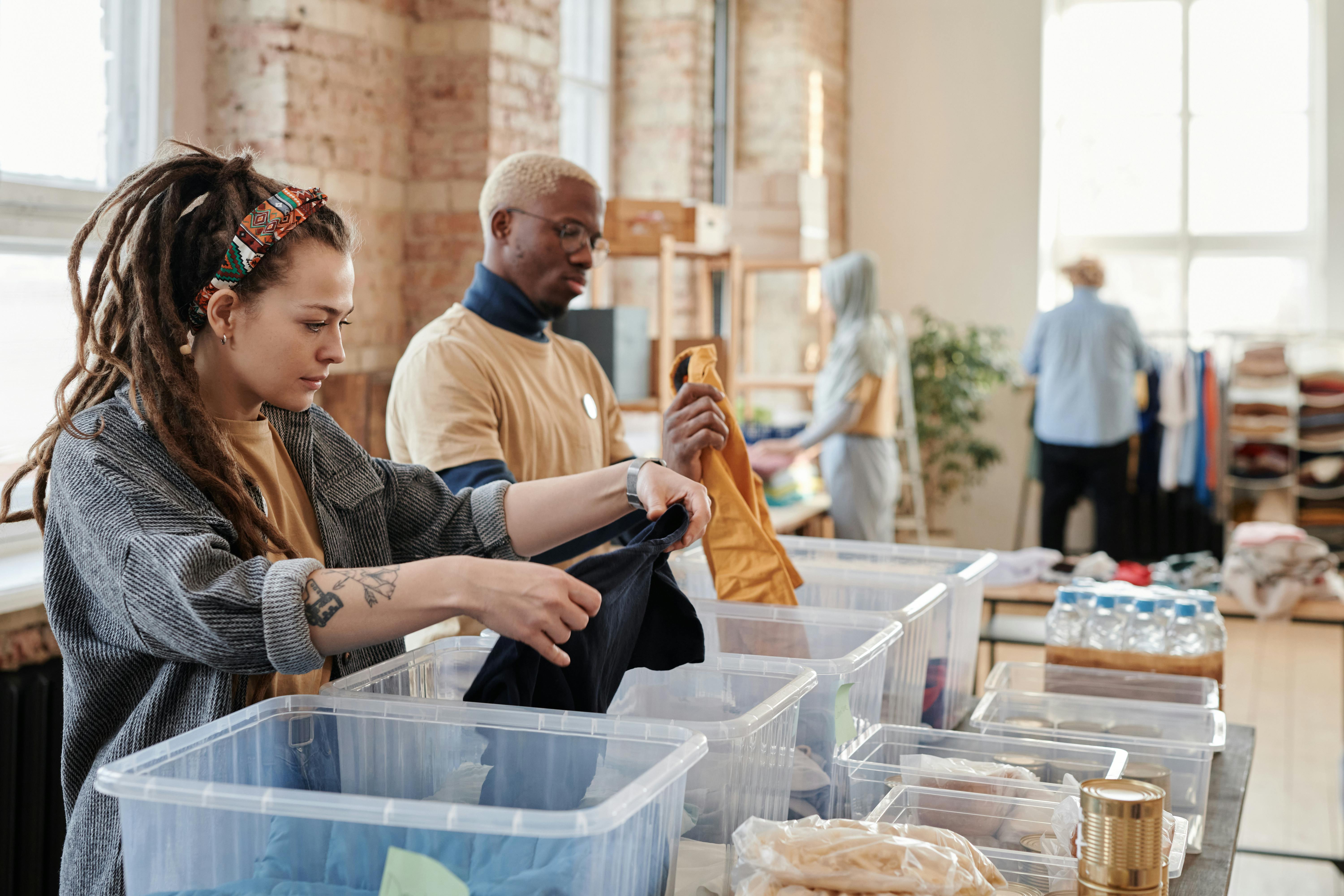 Volunteers organizing food and supply boxes.